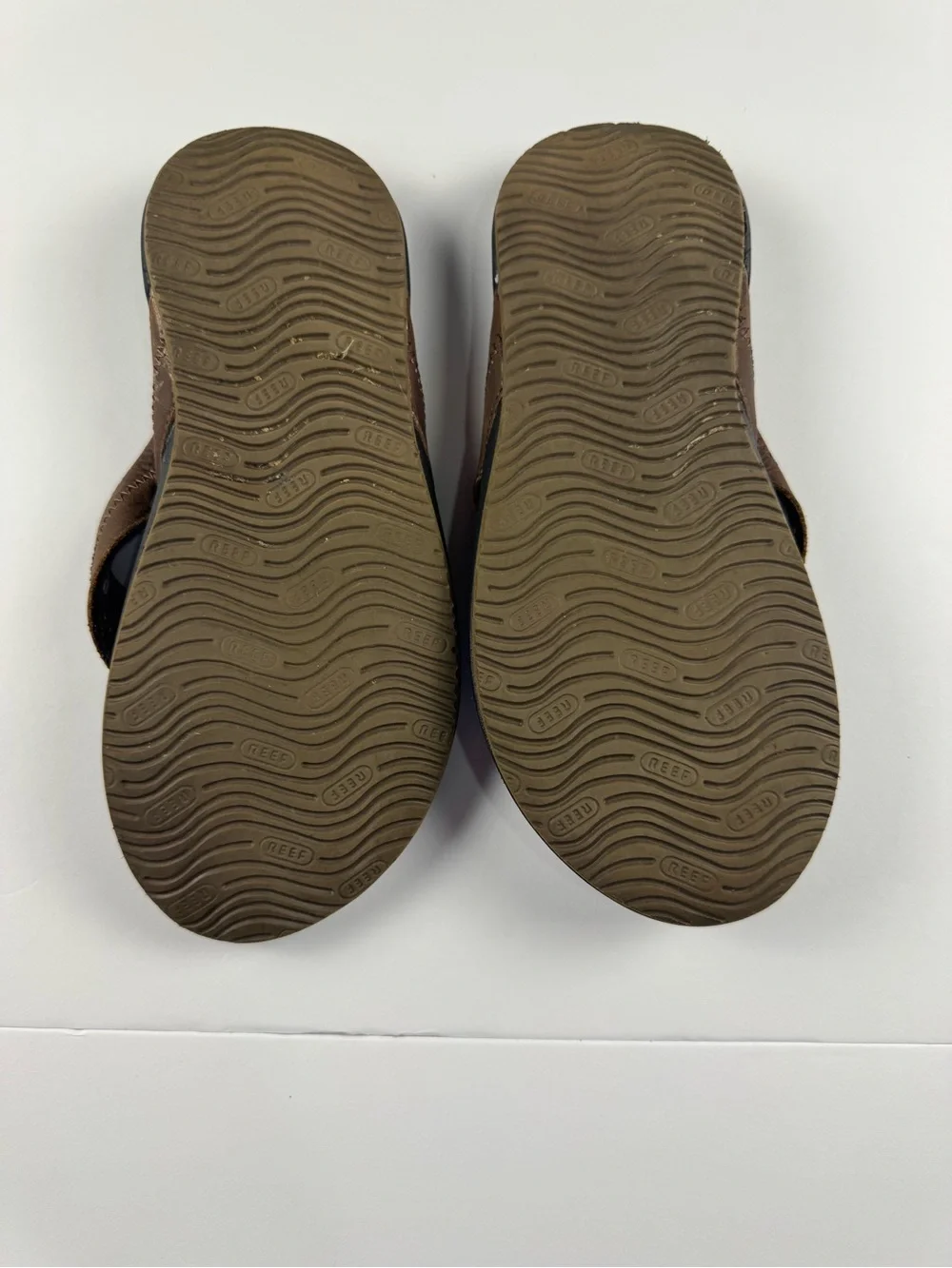 Reef Men's Brown and Black Leather-Style Flip Flops